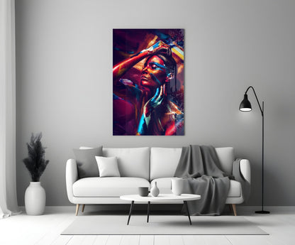 Colorful glass wall art featuring a woman's portrait with vibrant red, blue, and yellow light effects displayed above a white sofa.