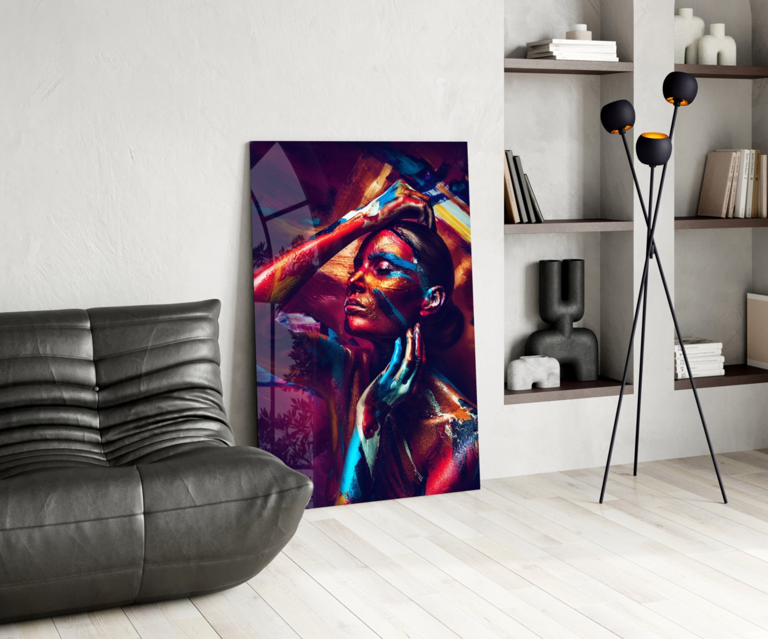 Vibrant glass wall art featuring a colorful portrait of a woman with red, blue, and gold lighting effects displayed in a modern living room setting.