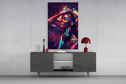 Colorful neon-lit female portrait glass wall art displayed above gray media console in minimalist interior setting.