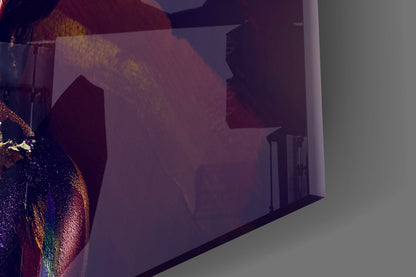 Colorful iridescent glass wall art with woman's profile casting shadow on white wall, photographed at angle.