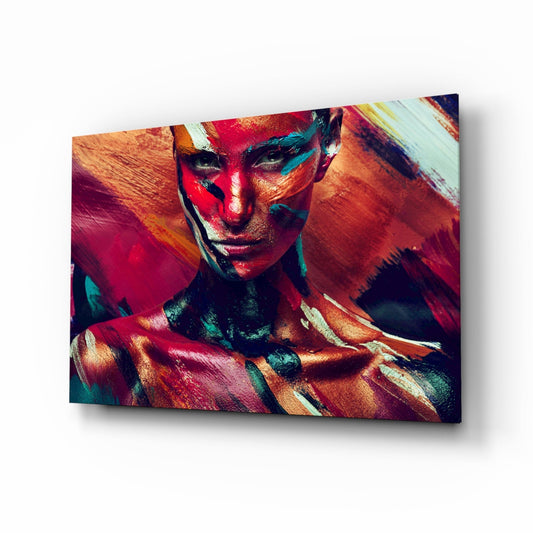 Woman's face and shoulders with vibrant red, teal, and gold geometric paint design on glass wall art panel.