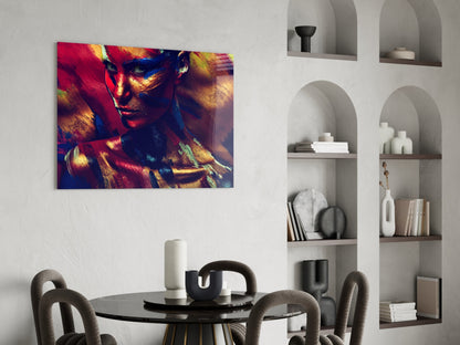 Vibrant glass wall art depicting a woman's face in red, gold, and blue tones displayed above a dining table.