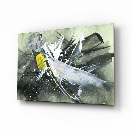 Angled perspective of glass wall art displaying abstract white brushstrokes with yellow accents on muted green and gray background.