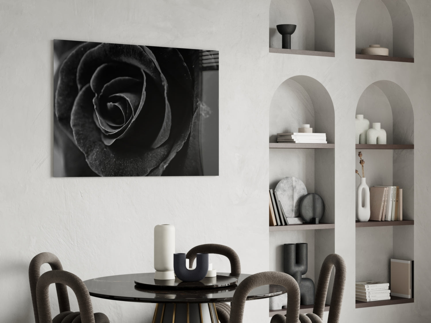 Black rose glass wall art displayed above a round black dining table with upholstered chairs and styled shelving.