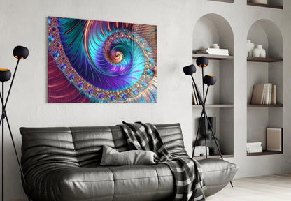 Vibrant abstract fractal spiral glass wall art in purple, teal, and gold displayed above a black leather sofa in a modern living room.