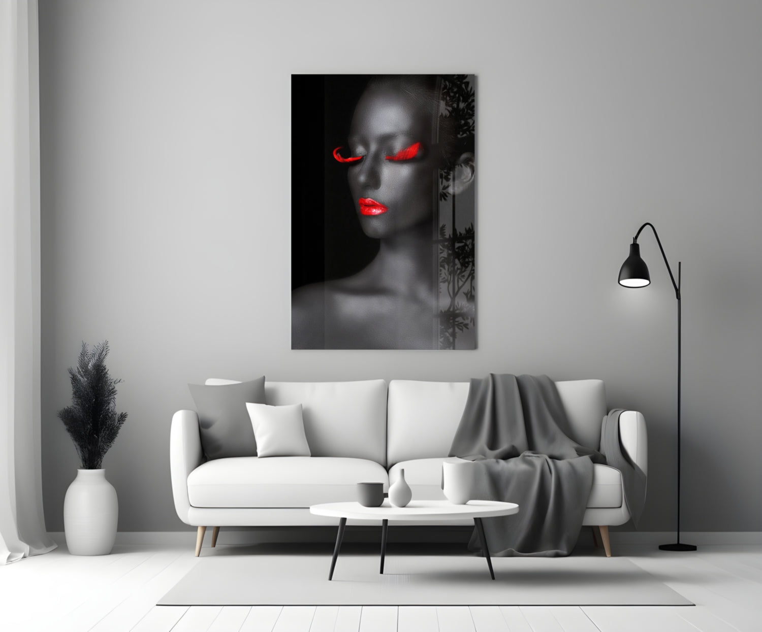 Woman portrait glass wall art with grayscale face and glowing red eyes and lips, displayed above white sofa in modern living room.