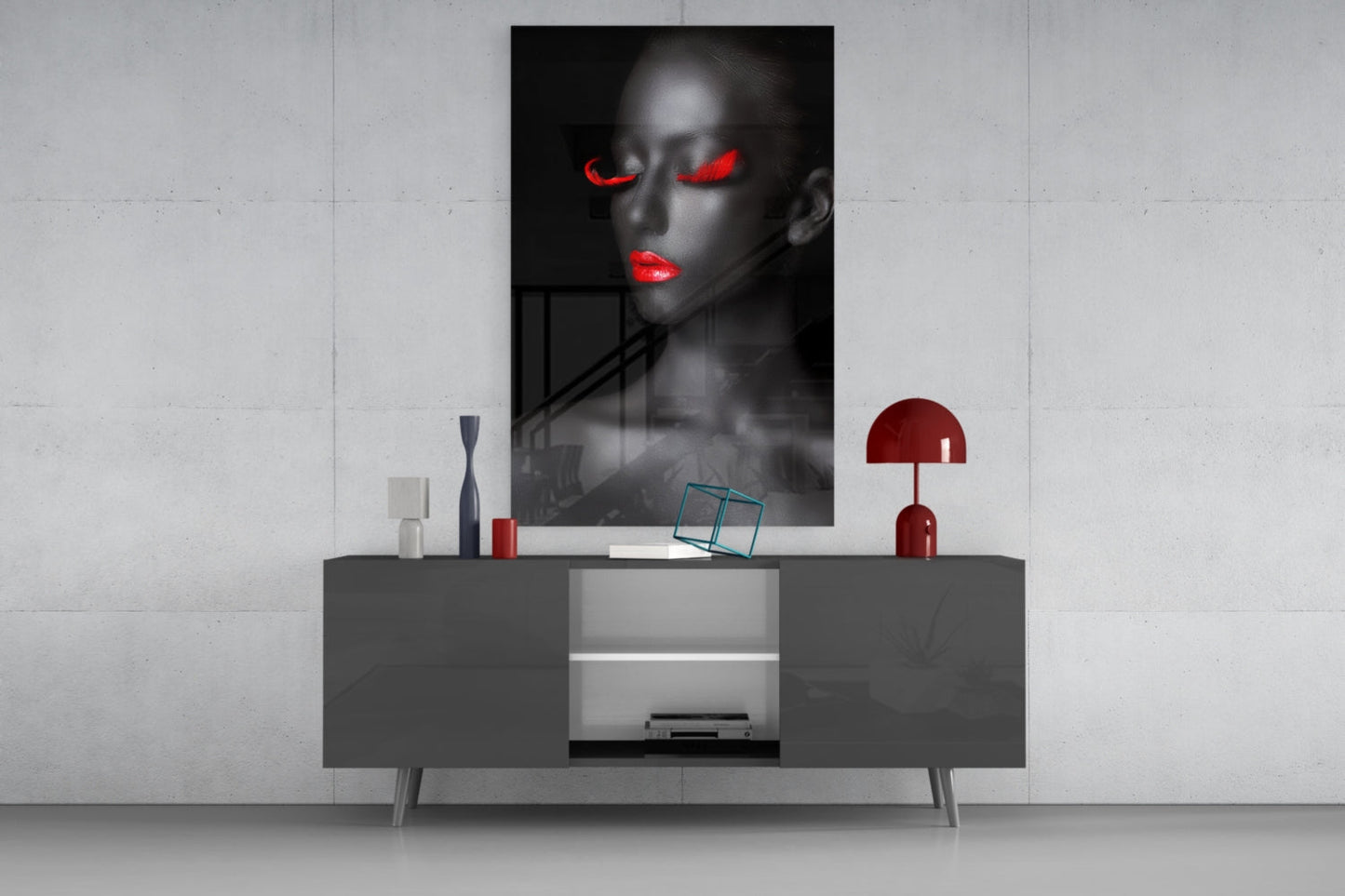 Black and white portrait with red glowing eyes and lips displayed above a gray console table with red decorative accents.