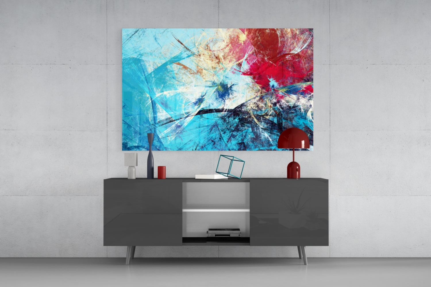Modern living room interior with blue, red, and cream abstract glass wall art displayed above a dark gray media console with decorative accessories.