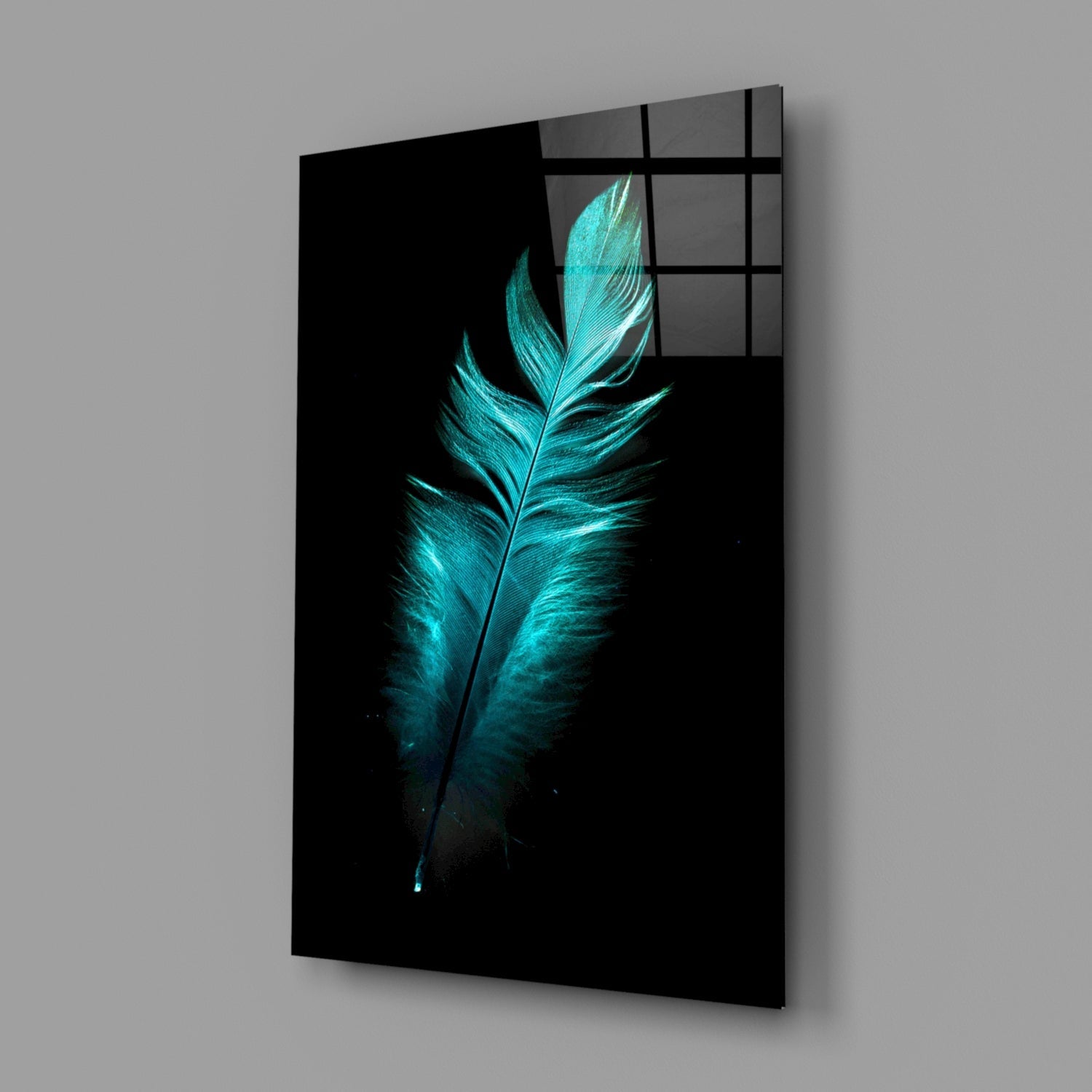Angled perspective view of turquoise glowing feather on black glass panel with grid window pattern overlay.
