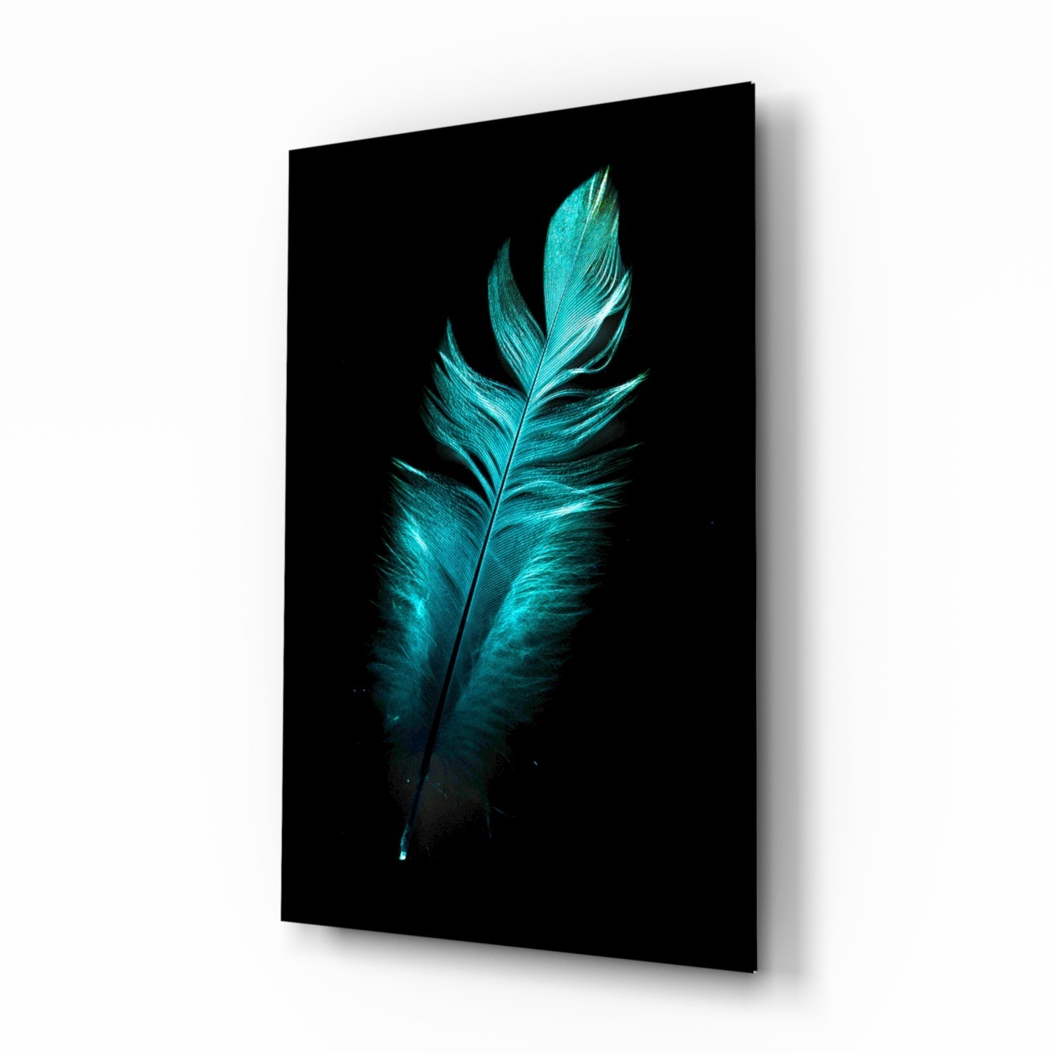Turquoise glowing feather on black glass panel displayed at an angled perspective showing depth and shadow.