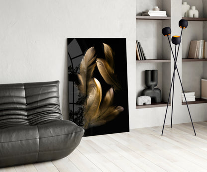 Tan feather glass wall art displayed in a modern living room beside a gray leather chair and black floor lamp with shelving.