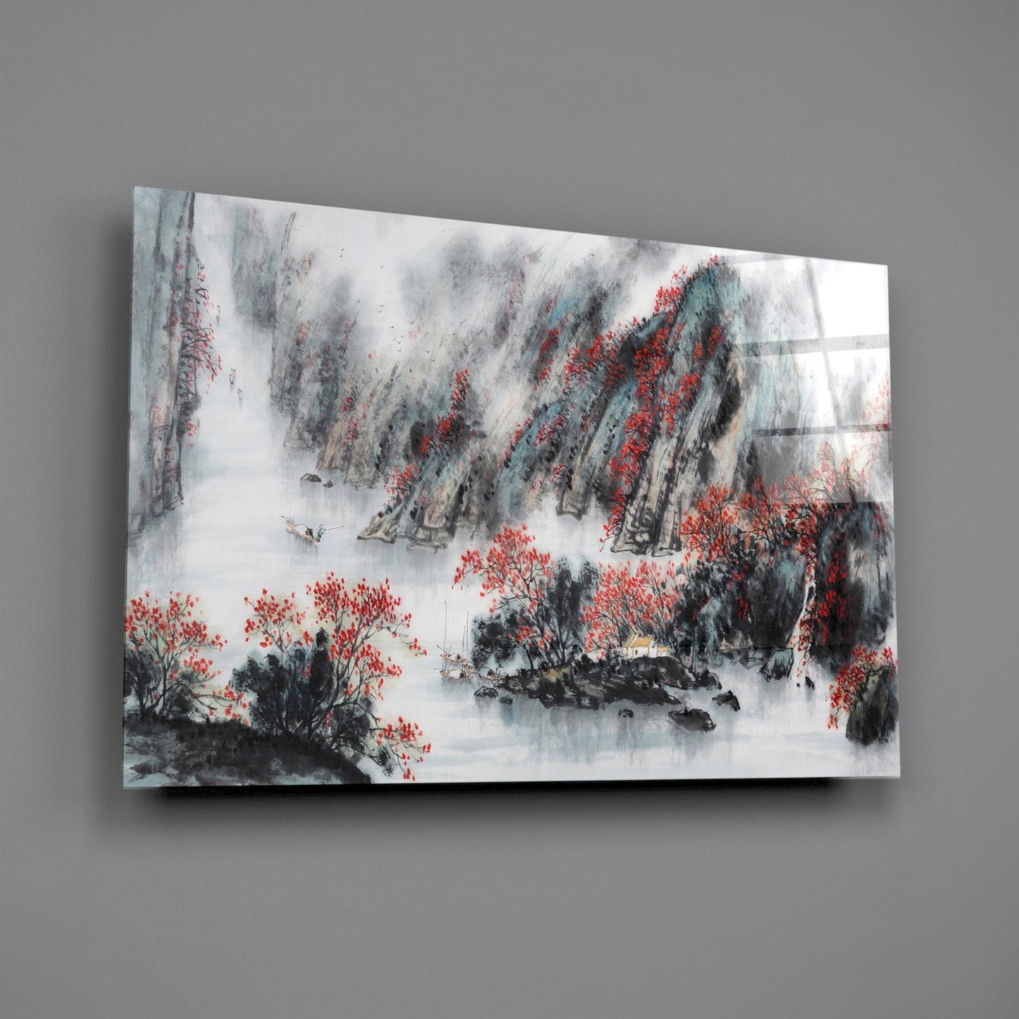 Glass wall art mounted on gray wall displaying misty landscape with red flowering trees, black ink brushwork, and white water in traditional Asian painting style.