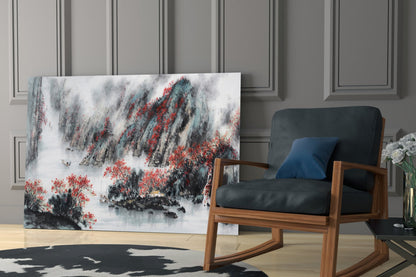 Japanese-inspired glass wall art depicting snow-covered mountains with red foliage displayed in a modern living room beside a wooden chair.