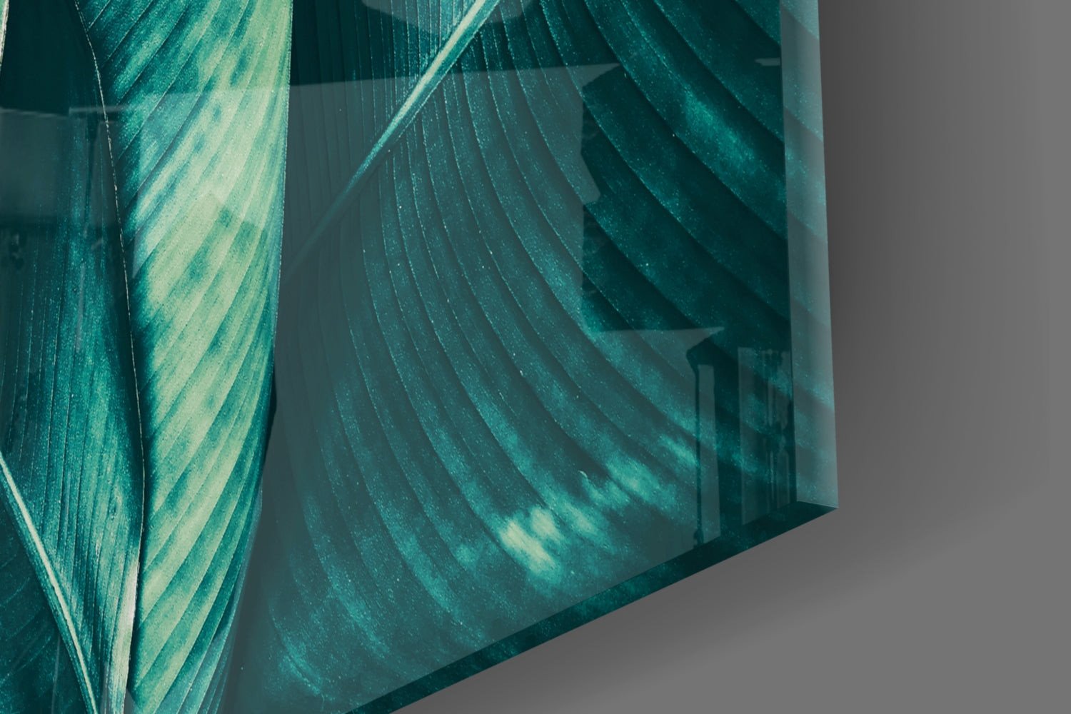 Close-up angled view of layered teal and pale green striped glass panels casting shadows on gray surface.