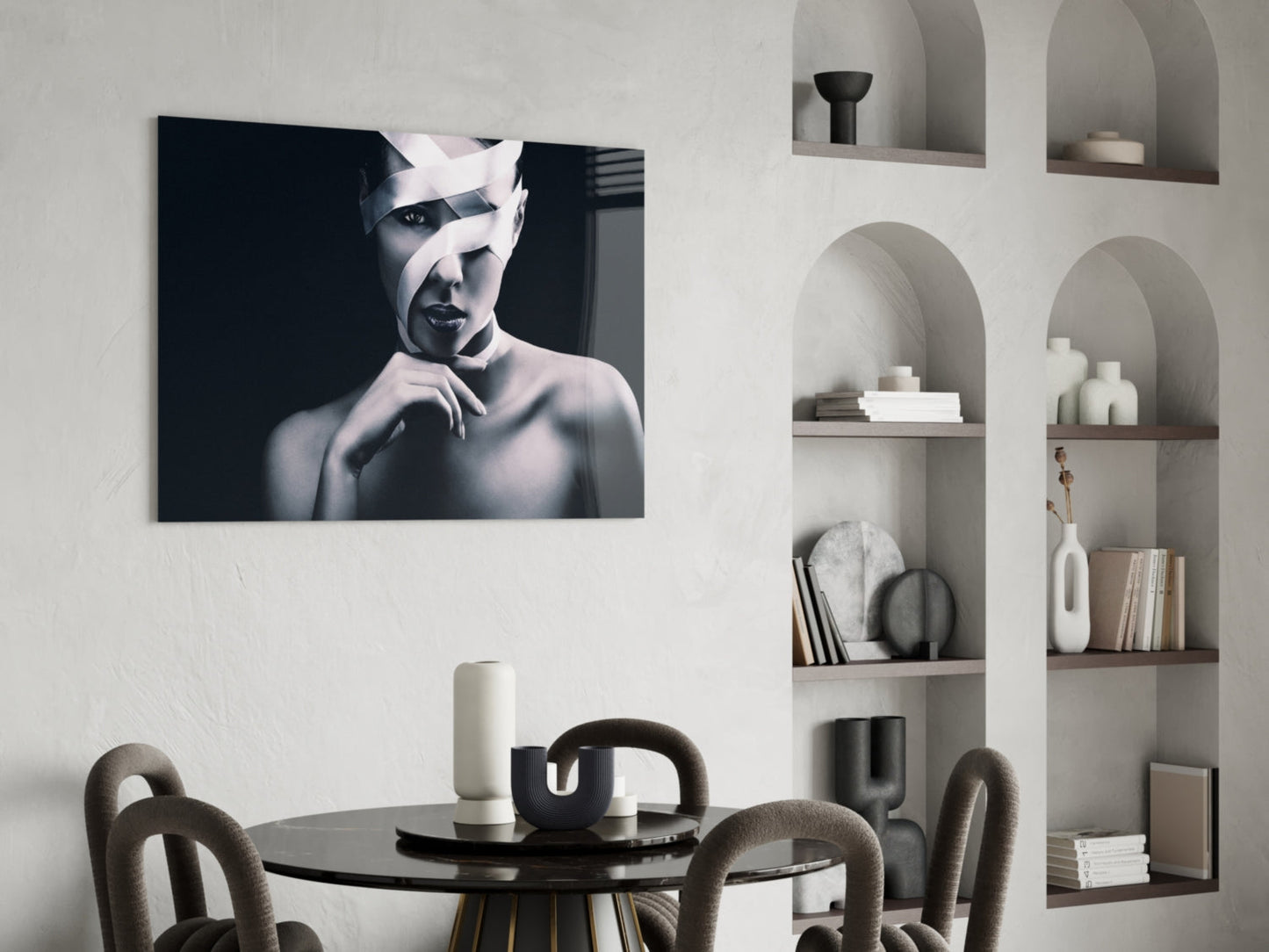 Black and white portrait of a woman with white bandages wrapped around her head, displayed as a glass wall art above a dining table.