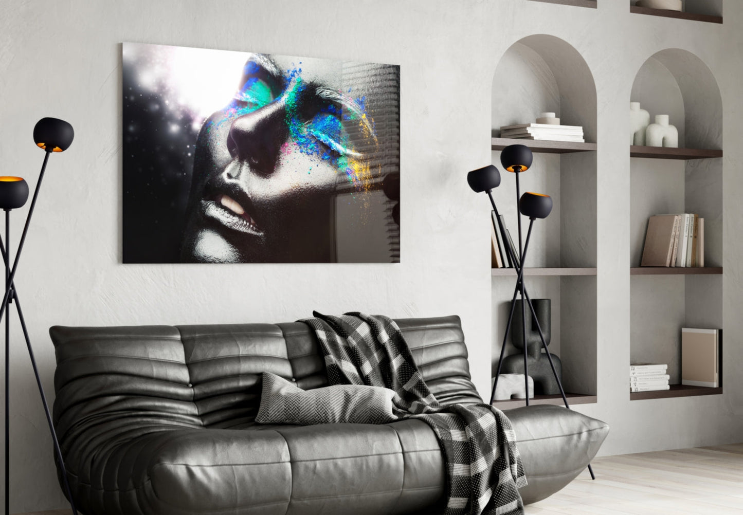 Modern living room interior featuring a glass wall art displaying a monochromatic female portrait with vibrant rainbow-colored paint splatter effects across the eyes and face.