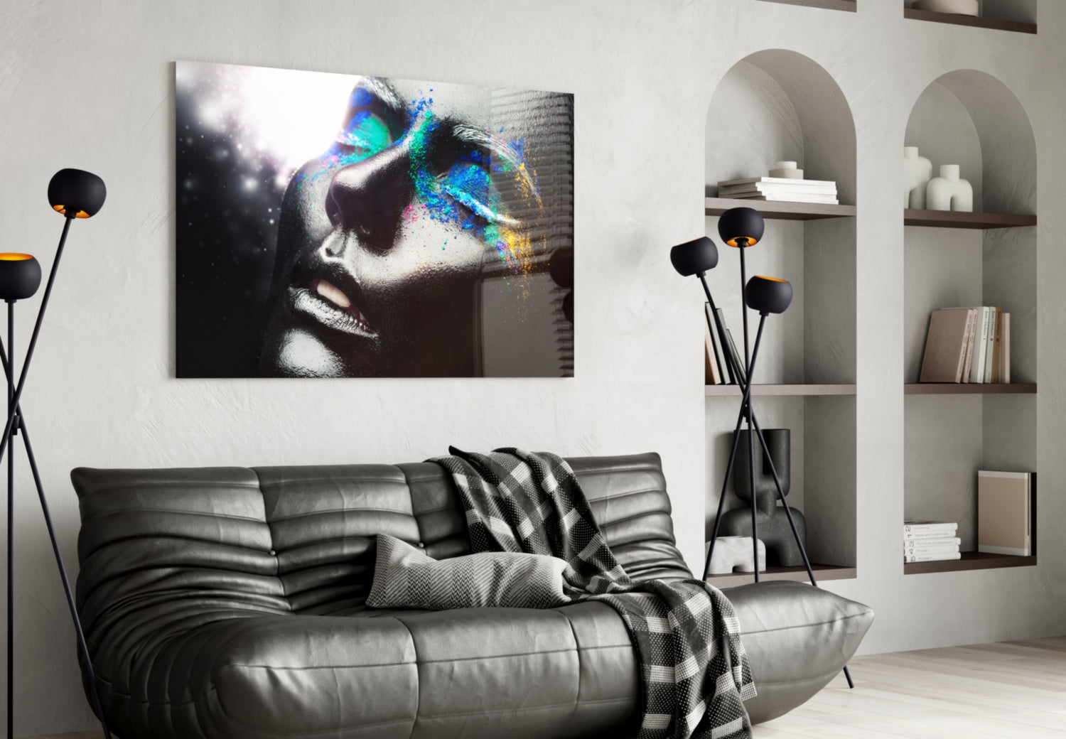 Modern living room interior featuring a glass wall art displaying a monochromatic female portrait with vibrant rainbow-colored paint splatter effects across the eyes and face.