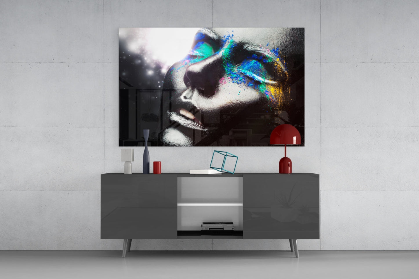 Modern living room with black and white portrait glass wall art featuring colorful neon geometric overlays displayed above gray media console.