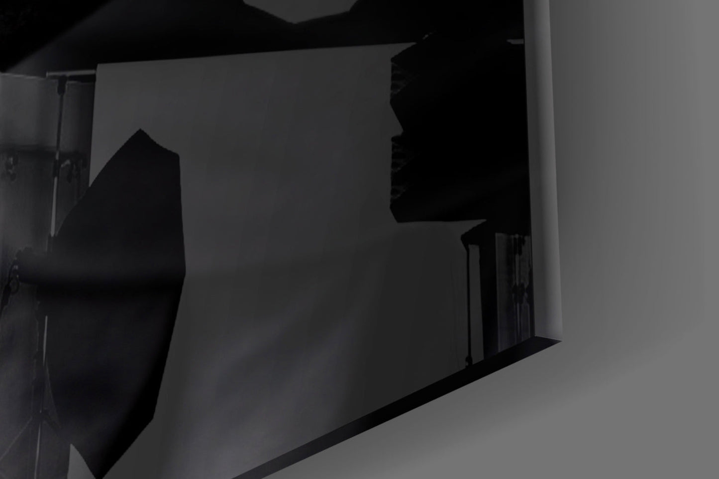 Silhouetted female profile etched into frosted glass panel, mounted on white wall with dramatic side lighting.