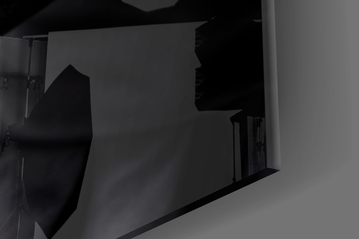 Silhouetted female profile etched into frosted glass panel, mounted on white wall with dramatic side lighting.