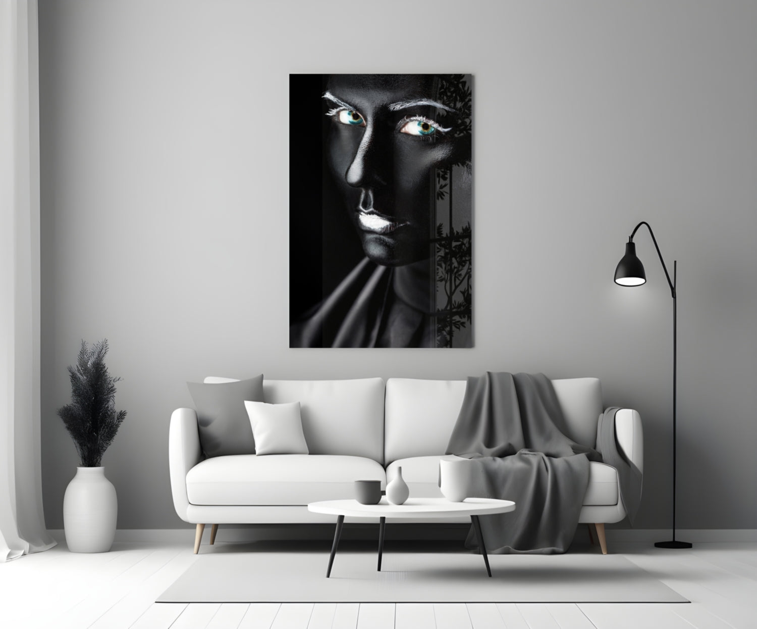 Black and white glass portrait of a woman with glowing eyes displayed above a white sofa in a modern living room.