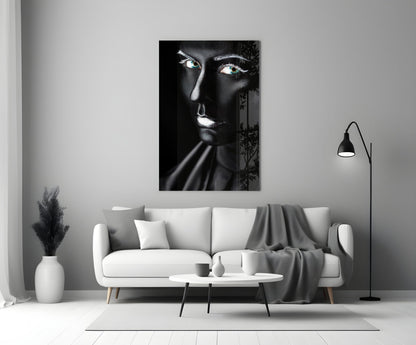 Black and white glass portrait of a woman with glowing eyes displayed above a white sofa in a modern living room.