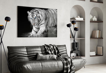 Black and white tiger glass wall art mounted above a grey leather sofa in a modern living room setting.