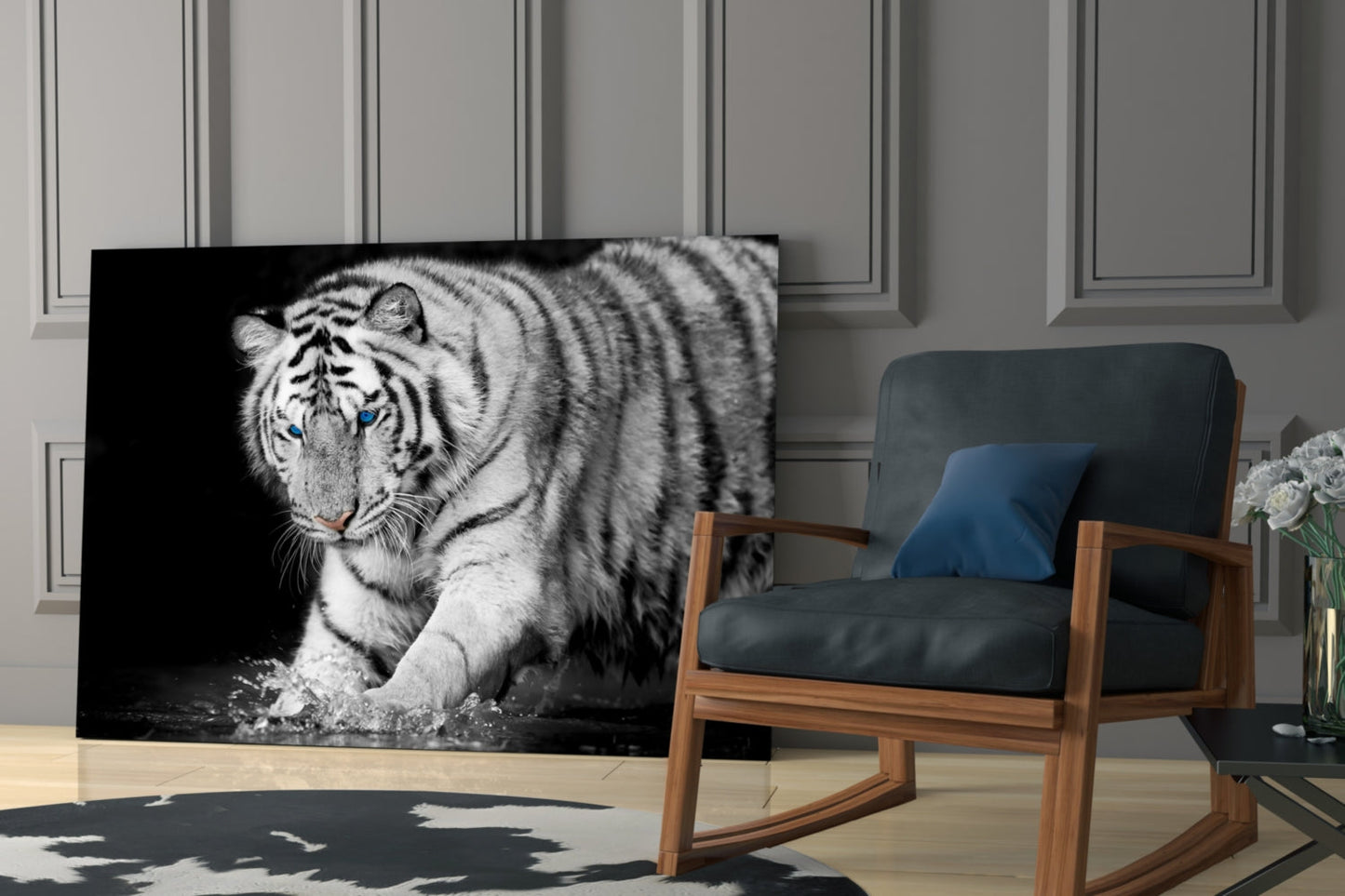 White tiger with blue eyes on black background glass wall art displayed in modern living room next to wooden chair.