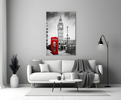 Black and white London street scene with iconic red telephone box and Big Ben displayed on glass wall art above white sofa.