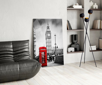 Black and white London street scene with iconic red telephone box and Big Ben displayed on glass wall art in modern living room setting.