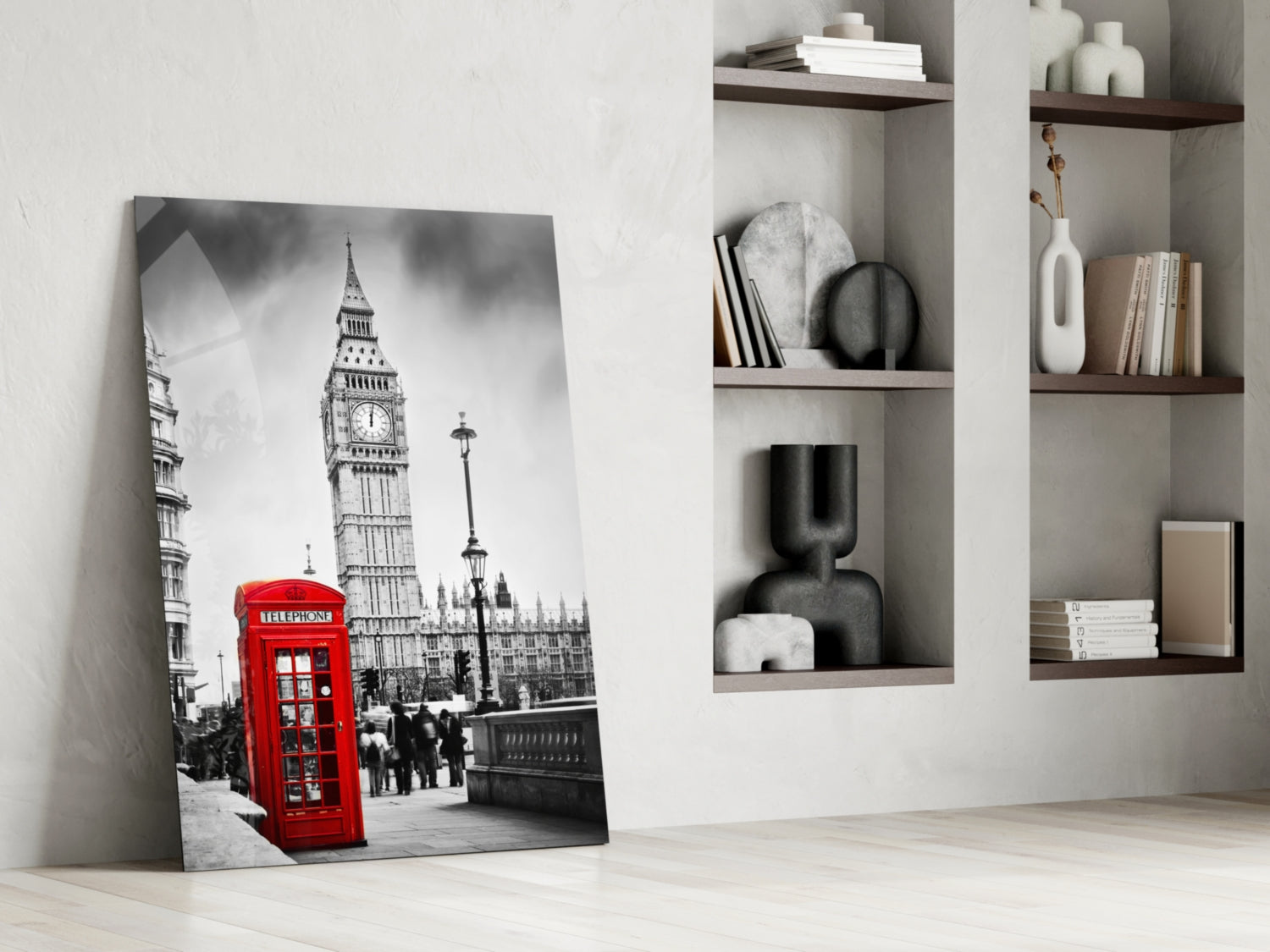 Black and white London street scene with iconic red telephone box and Big Ben leaning against white wall next to shelving unit.