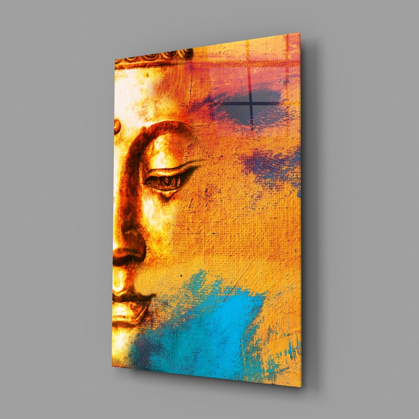 Buddha Portrait Glass Wall Art displayed at angle showing golden profile with turquoise lower section and textured surface.