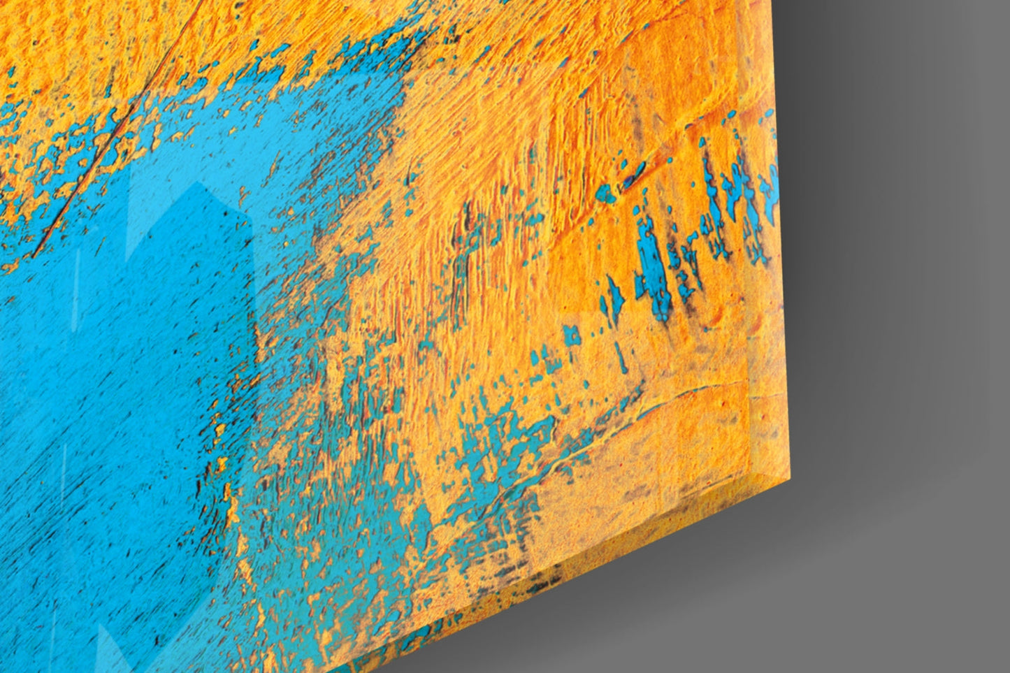 Close-up angled detail of textured glass surface showing blue and gold brushstroke patterns with visible wear.