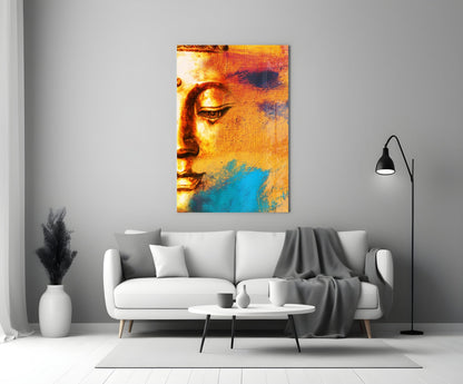 Buddha Portrait Glass Wall Art in warm gold and cool blue tones displayed above a white sofa in a minimalist living room.