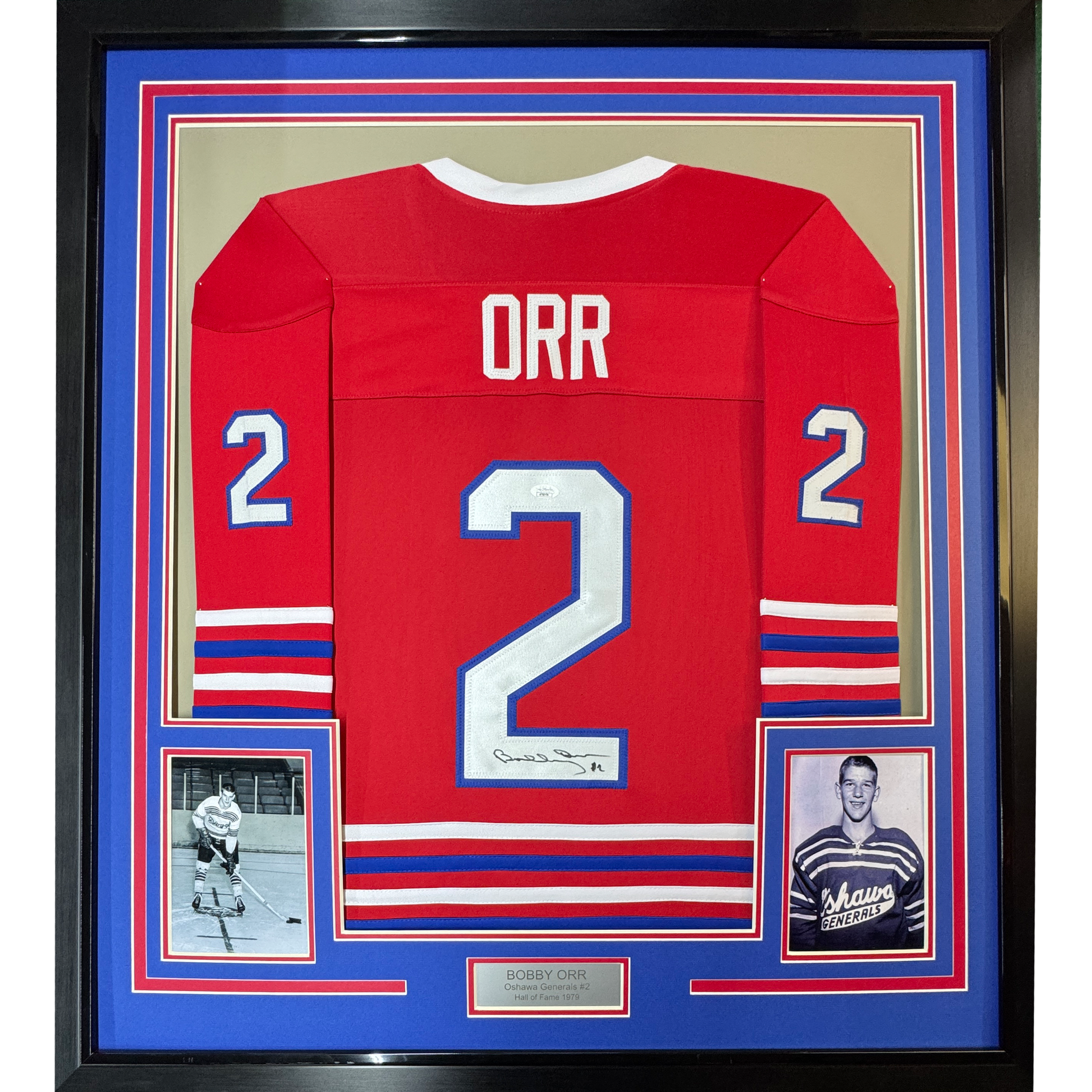 Framed red hockey jersey number 2 with "ORR" nameplate, signed, displayed with two black-and-white photos and blue matting.