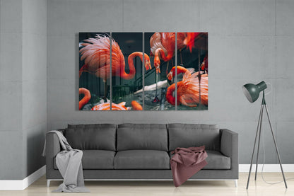 Four-panel glass wall art displaying vibrant red and orange flamingos installed above gray sofa in modern living room.