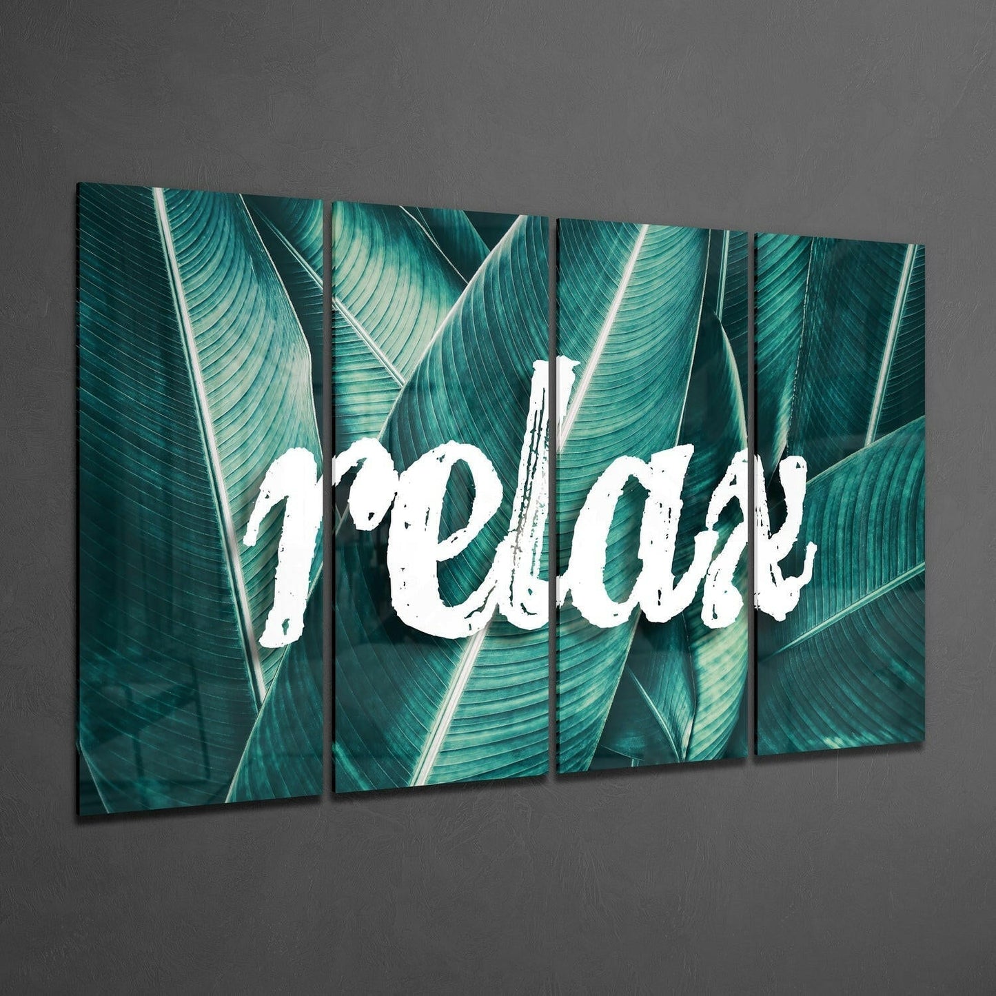 Four-panel glass wall art displaying white "Relax" text overlaid on teal striped banana leaves, mounted at an angle against gray wall.