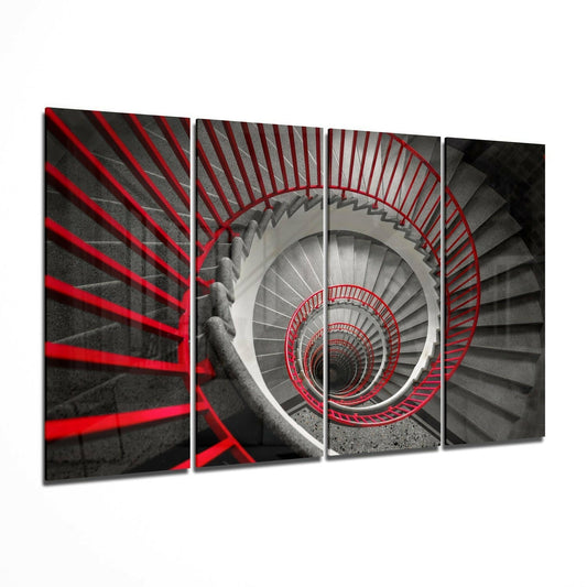 Overhead view of a spiraling staircase with red railings descending into depth against gray concrete steps.