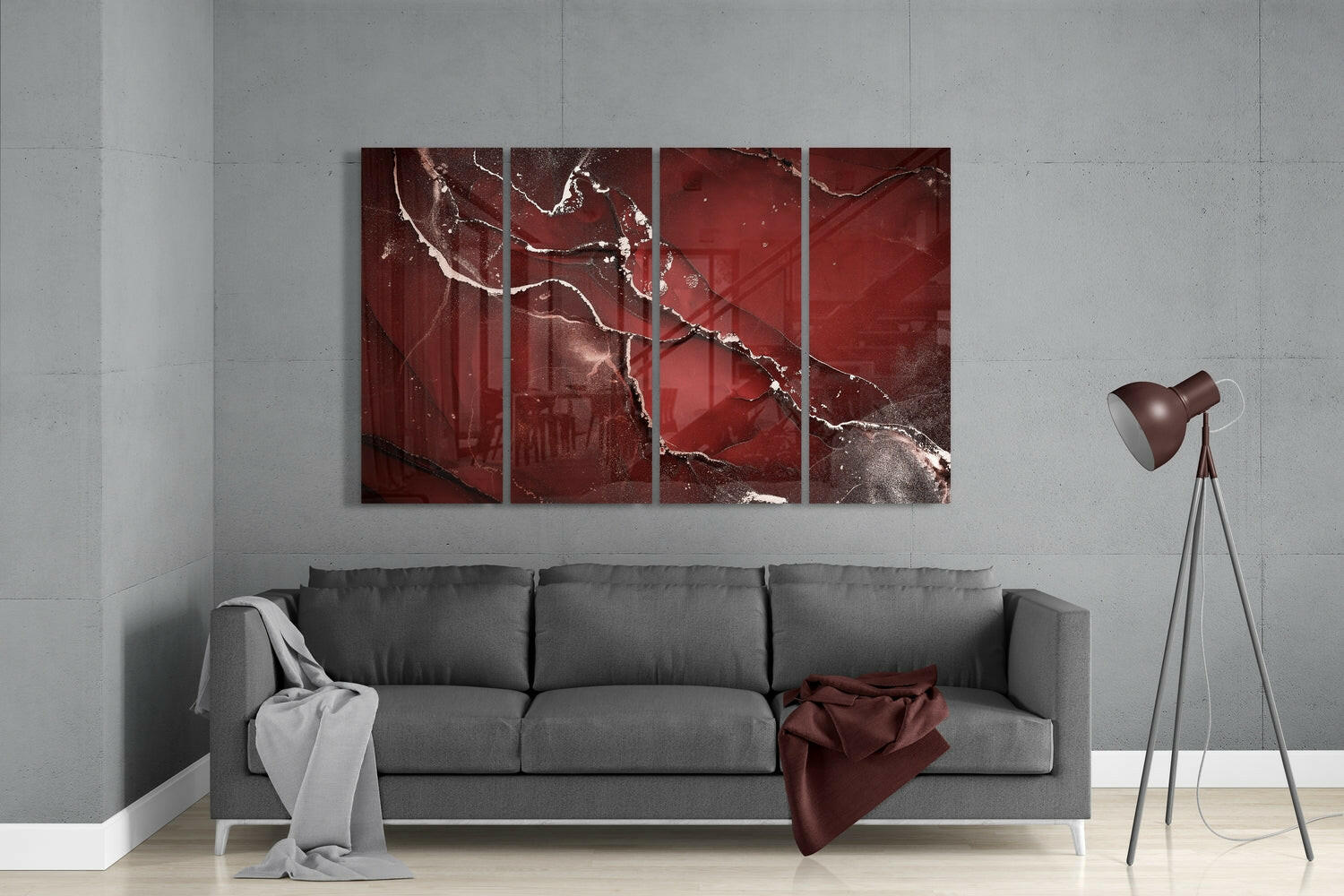 Modern living room with gray sofa displaying red cracked glass wall art panels above, alongside tripod floor lamp.