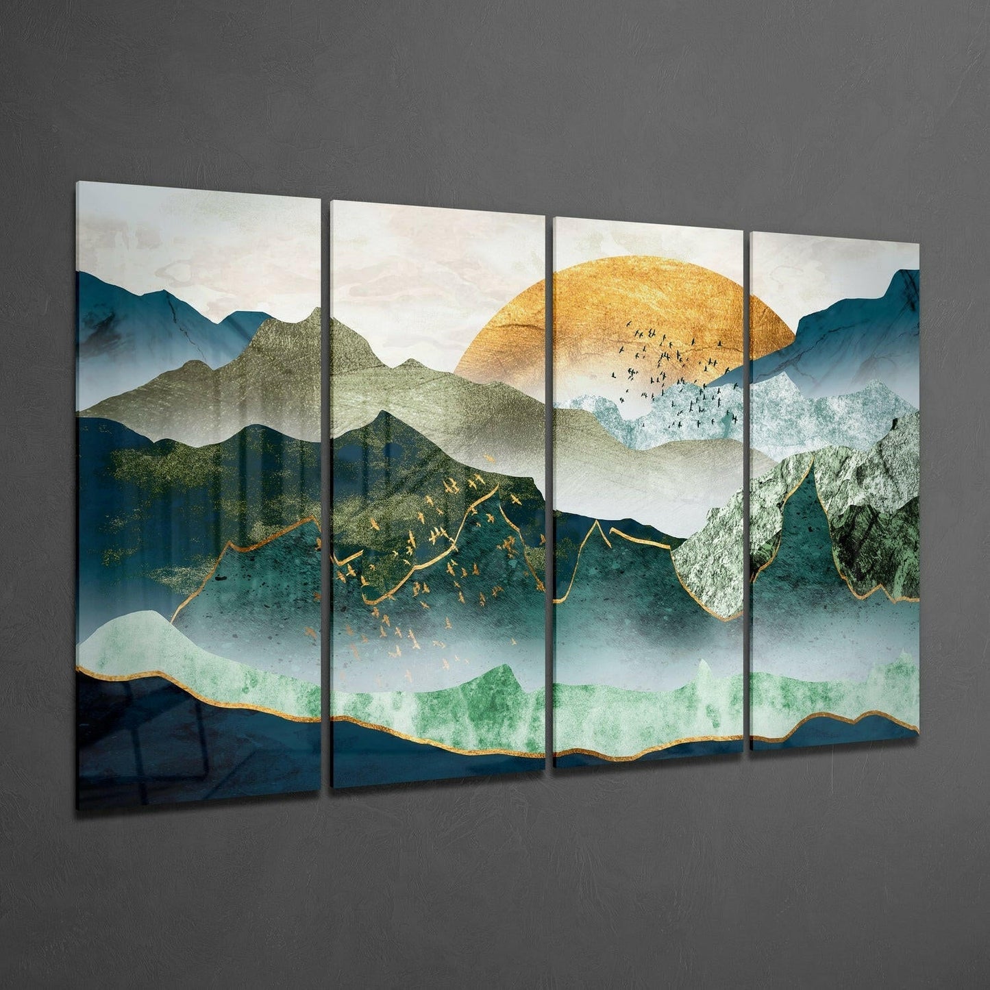 Four-panel glass wall art displaying layered mountains in teal and green with a golden sun, gold-outlined peaks, and small figures, mounted on gray wall.