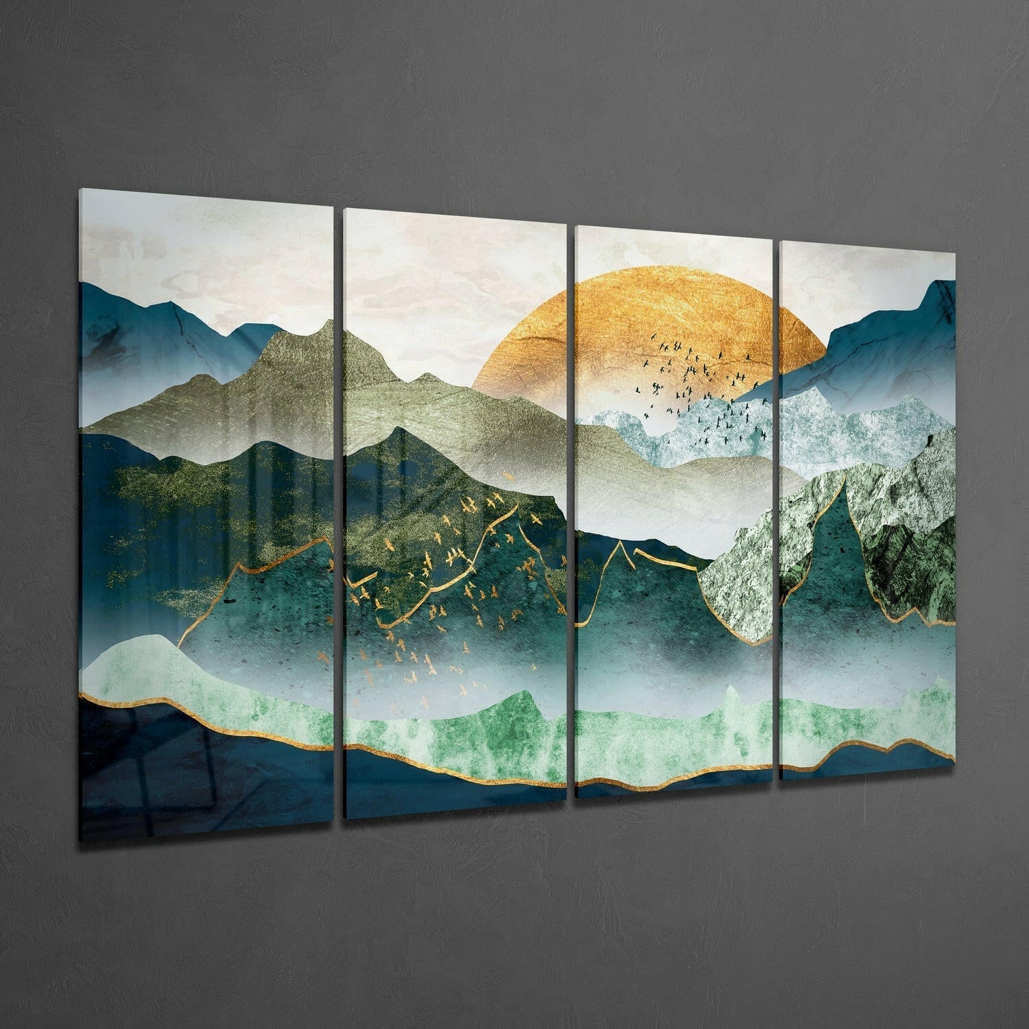 Four-panel glass wall art displaying layered mountains in teal and green with a golden sun, gold-outlined peaks, and small figures, mounted on gray wall.