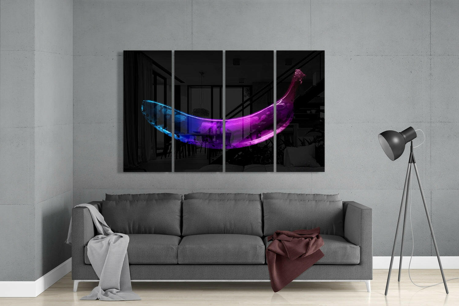 Modern living room with gray sofa displaying four-panel glass wall art featuring neon blue and purple glowing banana against black background.