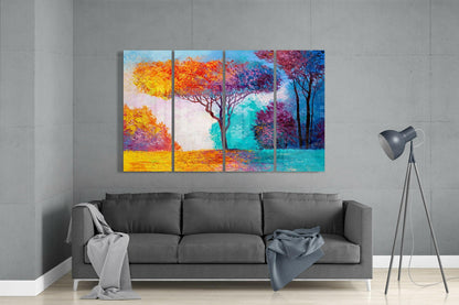 Colorful four-panel glass wall art depicting vibrant trees in yellow, orange, purple, and teal displayed above gray sofa in modern living room.