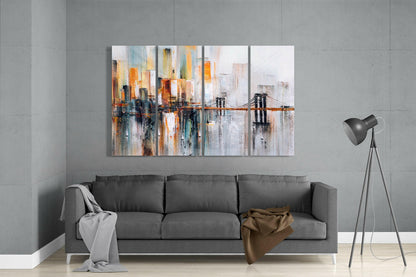 Four-panel abstract cityscape artwork displayed above gray sofa, featuring orange and blue vertical brushstrokes with suspended bridge detail.