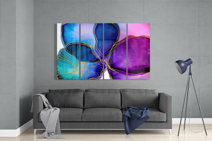 Modern living room with gray sofa displaying four-panel glass wall art featuring blue, pink, and purple abstract flowers with gold accents.