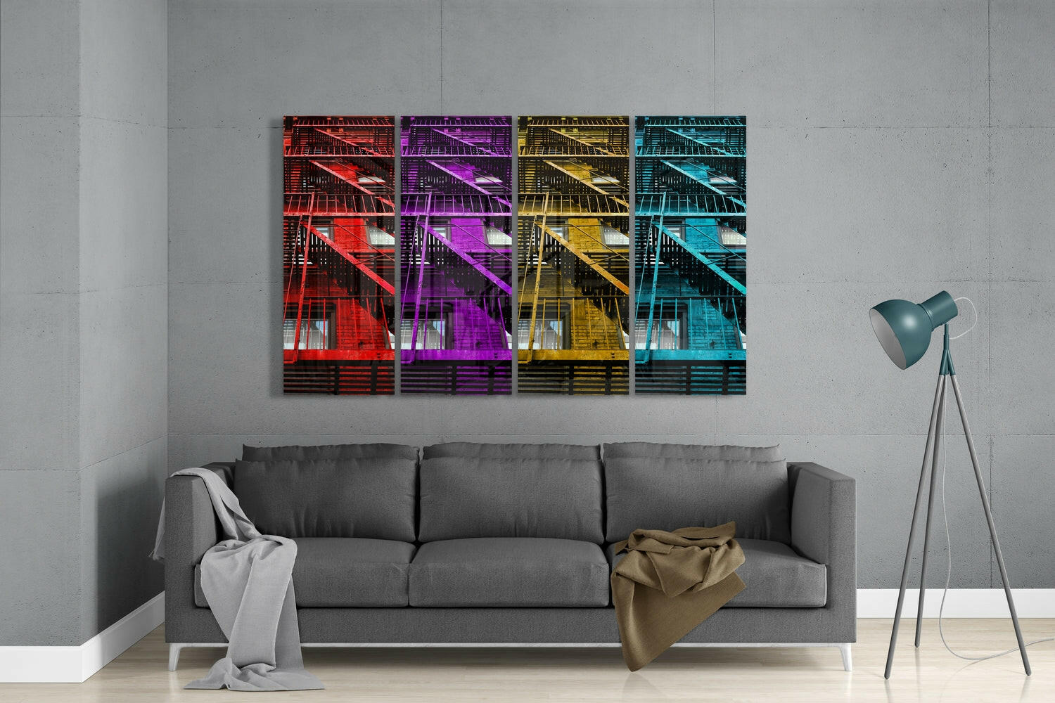 Four colorful glass panels with red, purple, yellow, and cyan architectural staircase designs displayed above a gray sofa in a modern living room.