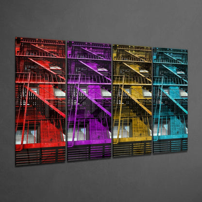 Four-panel glass wall art displaying colorful fire escapes in red, purple, yellow, and cyan against gray wall.