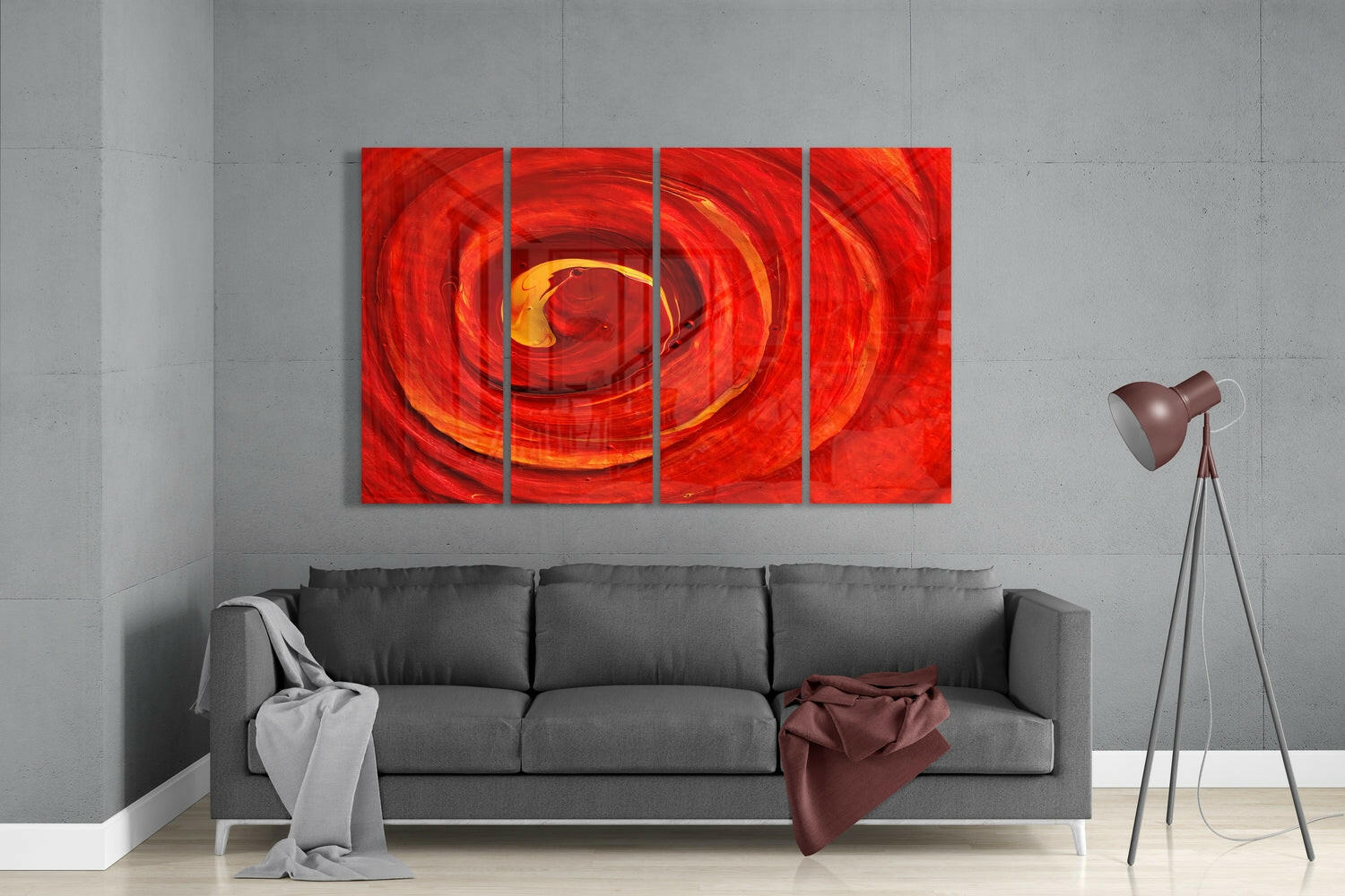 Four-panel red vortex glass wall art displayed above gray sofa in modern living room interior.
