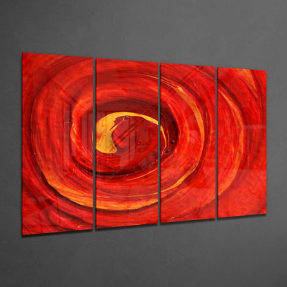 Four-panel red glass wall art displaying a swirling vortex with yellow and orange center, mounted on gray wall at angle.