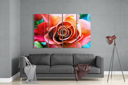 Vibrant multicolored rose artwork displayed as four glass panels above gray sofa in modern living room setting.